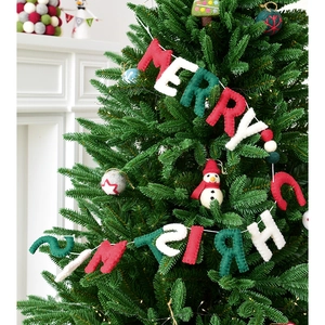 Felt Merry Christmas banner in red, white and green wrapped around a decorated pine tree