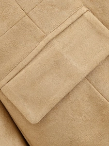 Close-up of premium stitching on khaki faux suede jacket pocket showing fine texture