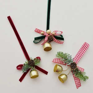 Christmas tree hanging ornaments set with velvet bows, pine cones and gold bells