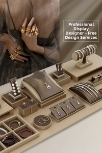Macro view of luxury dark brown leather jewelry display set with gold metal accents