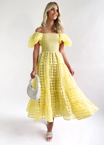 Detail of yellow off-shoulder tiered dress with puff sleeves and plaid textured fabric