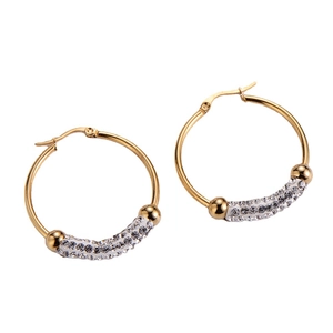 Golden hoop earrings with sparkling zircon crystals and ball accents on white background