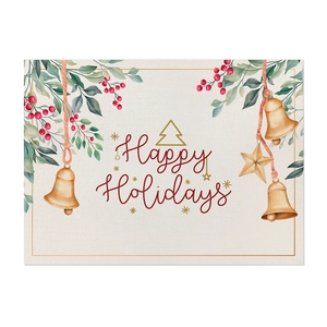 Close-up of linen Christmas placemat featuring green leaves, red berries and holiday bells