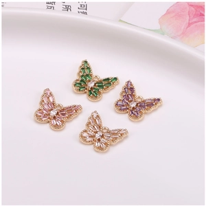 Detail of four butterfly pendants with gold plating and colorful zircon stones