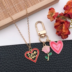 Detailed view of red and pink enamel heart charms with I Love You engraving on jewelry pieces
