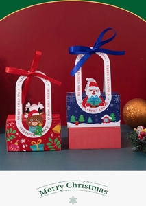 Close-up of festive Christmas gift boxes featuring red reindeer and blue Santa designs