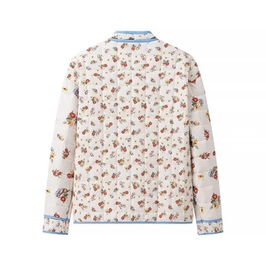 Rear view of floral quilted cotton jacket featuring blue piping and colorful flower print