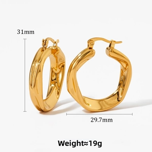 Detailed macro view of irregular twisted gold hoop earrings with dimensions 31mm and 29.7mm