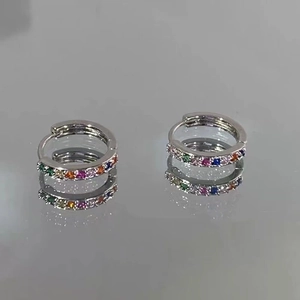 Detail shot of silver rainbow hoop earrings with colorful cubic zirconia stone inlays