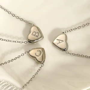 Polished stainless steel heart pendant necklaces with engraved letters A, B, and C