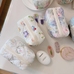 French style floral quilted cotton cosmetic bag shown in top-down flat lay view