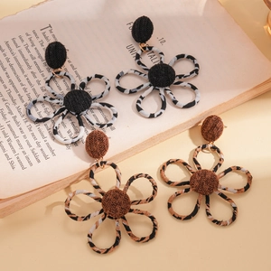 Retro leopard print and striped fabric flower earrings on an open vintage book background