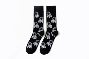 Close-up of black cotton crew socks with all-over pug dog pattern and knit texture