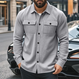 Detail of grey fleece-lined shirt jacket with black buttons and double chest pockets