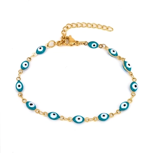 Detail of evil eye charm bracelet with golden chain, enamel beads, and lobster clasp closure