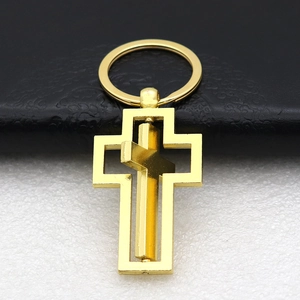 Golden rotating cross keychain in polished alloy with inner spinning cross for car keys