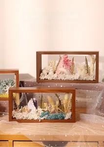 Wooden 3D shadow box frame showcasing colorful dried flowers and wedding dress insert