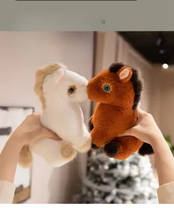 Close-up of soft plush horse toys in beige and brown with golden embroidered eyes