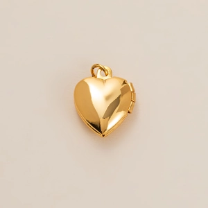 Close-up of heart-shaped gold locket with polished finish and functional side hinge