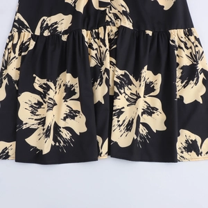 Black long-sleeved midi dress with beige floral print and pleated skirt details