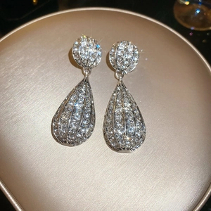 Macro view of teardrop earrings with silver-plated metal and sparkling crystals