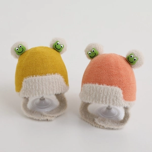 Yellow and pink baby knitted earflap hats with plush lining and cute frog pom-poms