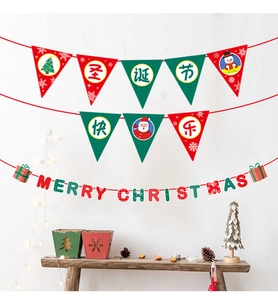 Red and green Merry Christmas bunting flags hanging on wall with festive pine cones