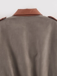 Detail of contrast suede jacket featuring brown leather collar and high-quality stitching