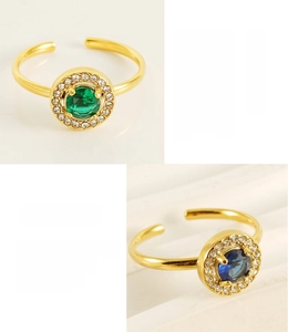 Detail view of double-layer 18K gold plated rings with green and blue zircon gemstones