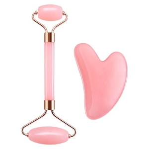 Pink rose quartz facial roller and heart-shaped gua sha massage set on white background