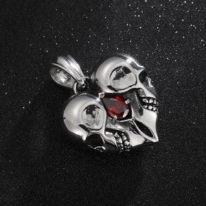 Gothic heart-shaped skull pendant with red gemstone in polished stainless steel finish