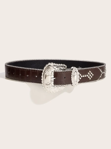 Detail of dark brown crocodile texture leather belt with silver engraved buckle and studs