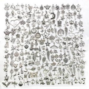 Macro view of assorted antique silver alloy charms featuring hearts, owls, and keys