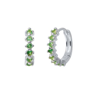 Detailed view of silver huggie earrings with five brilliant green cubic zirconia stones