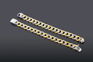 Detail of men's two-tone gold and silver Cuban link bracelets with polished finish