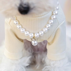Detail of luxury pet pearl necklace with sparkling crystal butterfly pendant on a dog