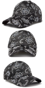 Close-up of floral embroidery and sparkling rhinestones on black cotton baseball cap