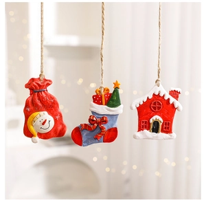 Close-up of Christmas resin pendants with snowman gift bag and stockings on rustic ropes