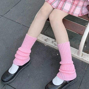 Close-up of pink knitted leg warmers for girls in a soft Japanese Lolita style