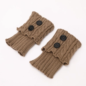 Detail of brown cable knit leg warmers with black button accents and ruffled edges