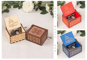 Macro shot of mechanical hand crank music box with Happy Birthday wood engraving