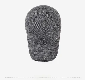 Top view of grey plaid woolen baseball cap for elderly men with metal logo detail
