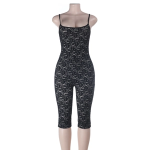 Detailed close-up of sexy black lace jumpsuit featuring hollowed fabric and slim-fit texture