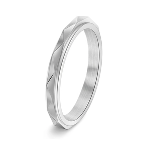 Macro shot of silver stainless steel ring featuring modern geometric faceted patterns