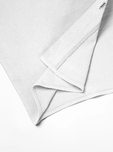 Macro shot of white knitted fabric texture and precise buttonhole stitching details