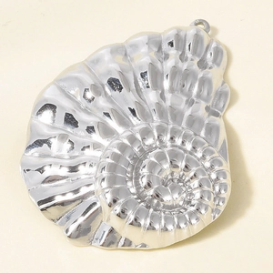 Detailed macro view of silver conch shell pendant with 3D spiral texture in stainless steel