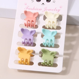 Detailed view of six colorful butterfly hair claws in pastel shades on a display card