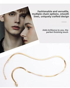 Detailed view of golden snake chain necklace showing flat blade links and lobster clasp