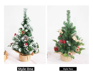 Close-up of mini snow-flocked Christmas trees with red berries and burlap base