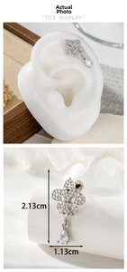 Detail showing iris drop earrings with cubic zirconia and precise 2.13cm size measurement